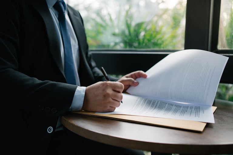 Businessman signing a document showcasing legal agreement and professional commitment
