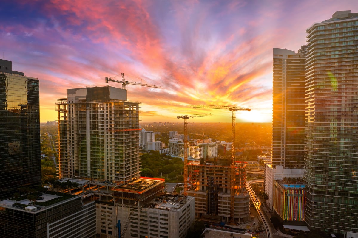 New high-rise buildings under construction at sunset