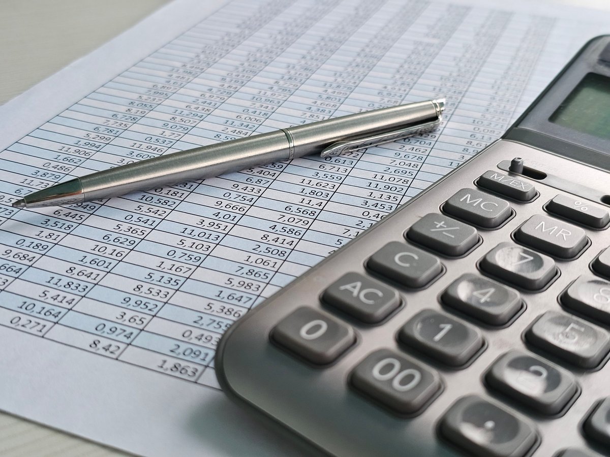 Financial calculations on paper with calculator and pen